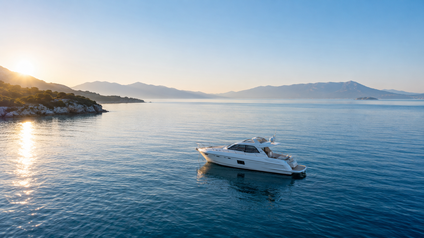 A motor yacht at a calm coastal anchorage, illustrating life on the water